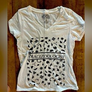 White Magizoologist tee shirt size large fits on smaller end.